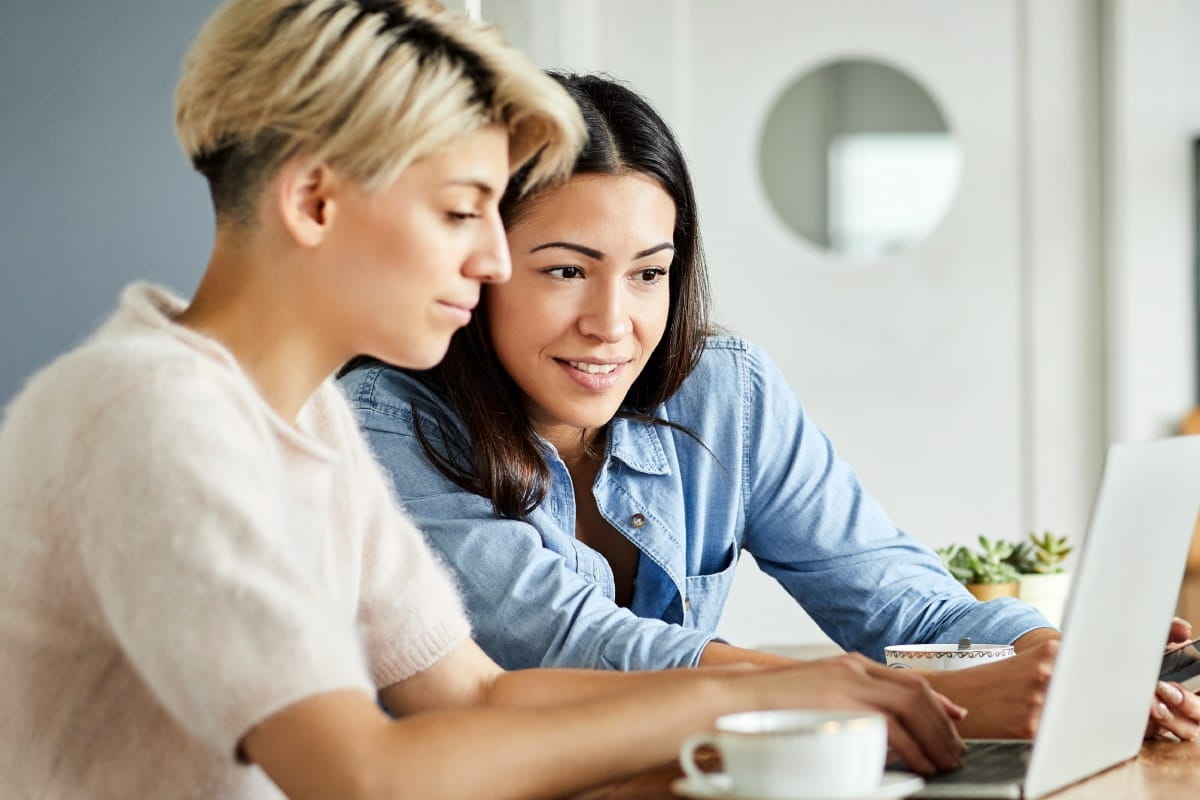 Two girls looking at the laptop