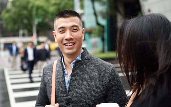 Young man smiling talking with woman