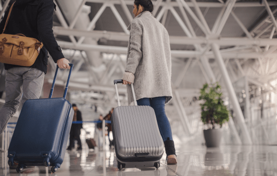 Travelers at airport with suitcase