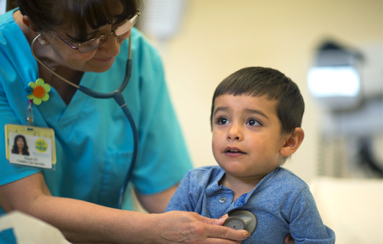 Small boy being examined my a medial practitioner.