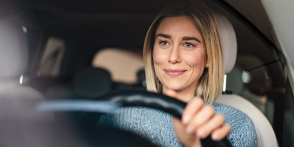 blond woman driving a car
