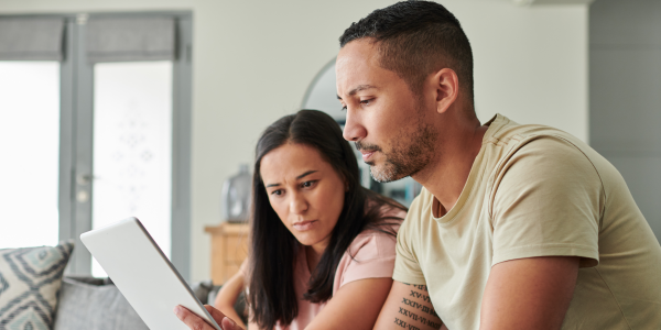 man and woman looking at a tablet