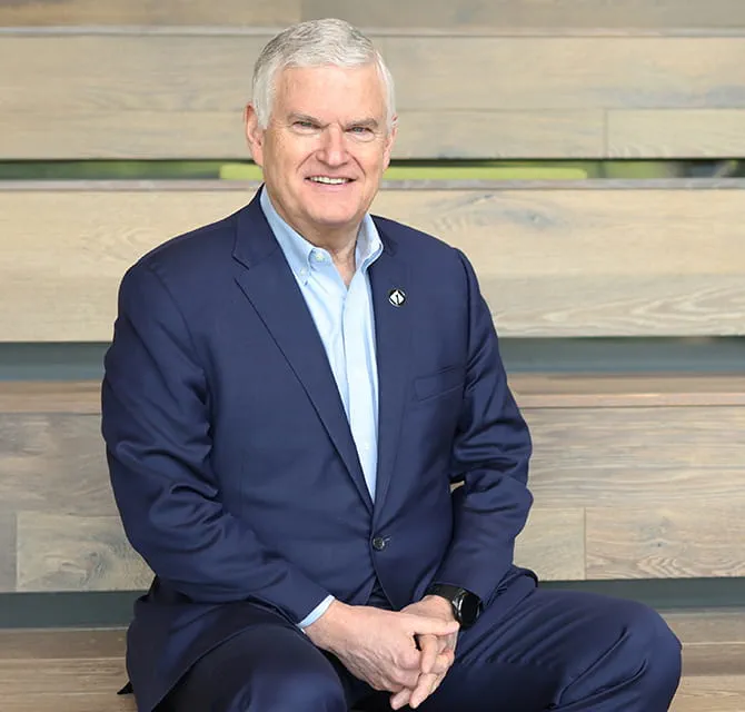 CEO sitting on bleachers smiling