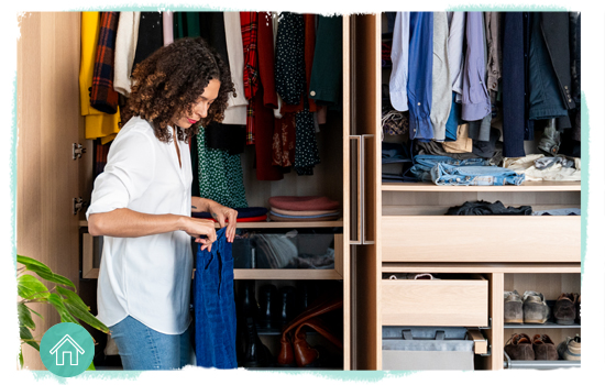 woman going through clothes in a closet