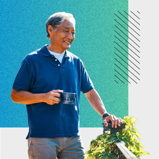 Man holding coffee mug while smiling