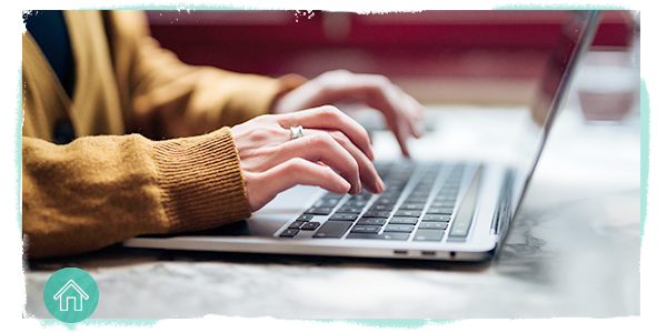 hands typing on a laptop keyboard