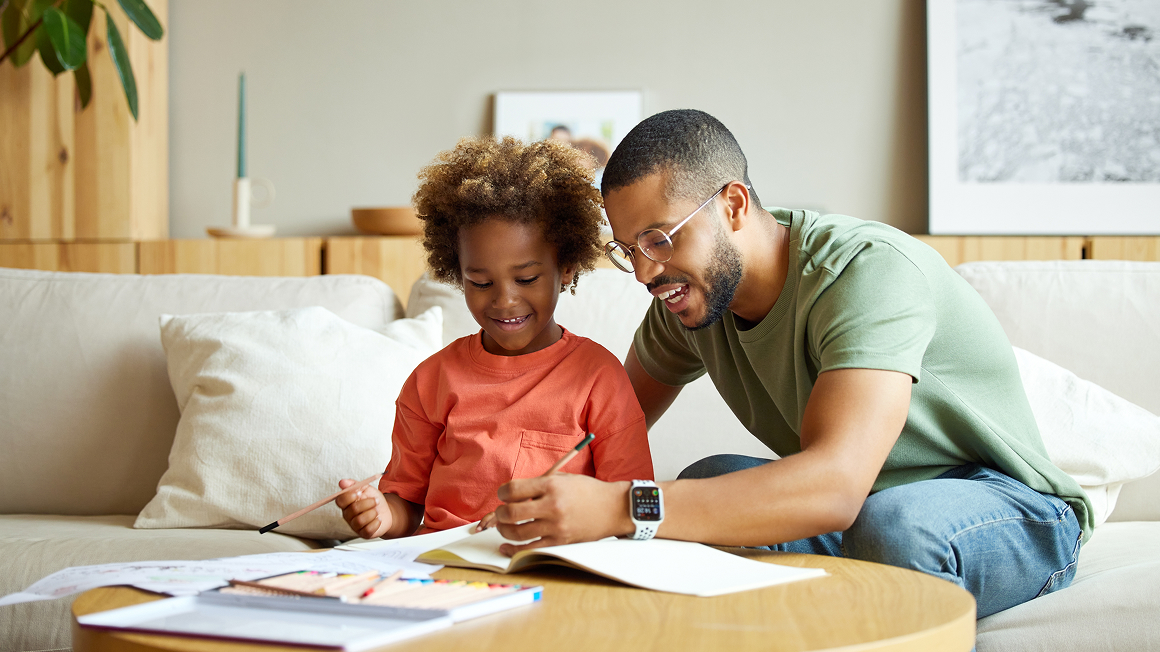 Man with young child doing home work