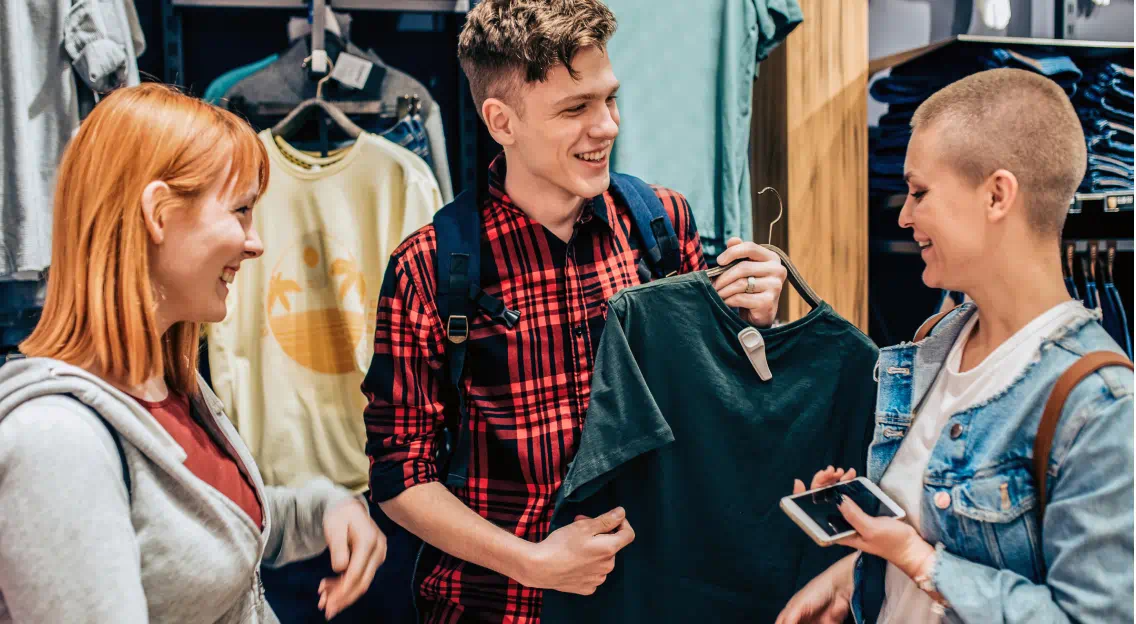 Three people purchasing clothing