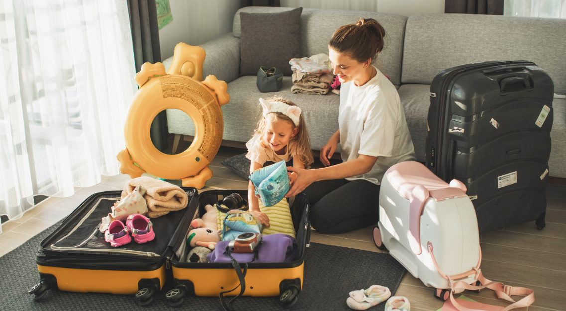 Woman and small child packing for a trip.