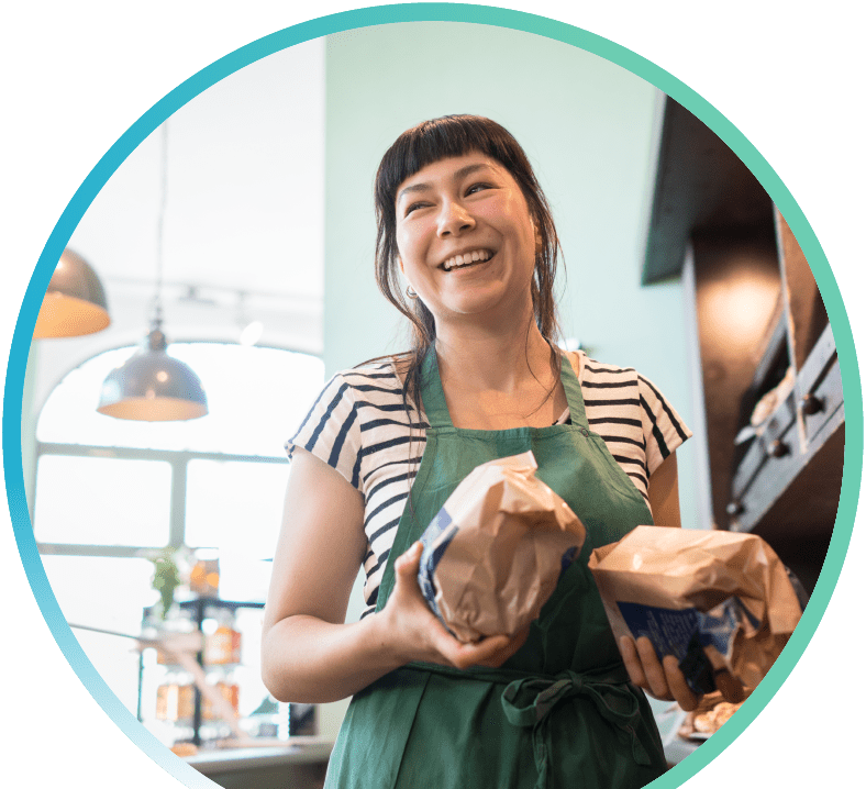 Barista holding two bags of coffee beans.