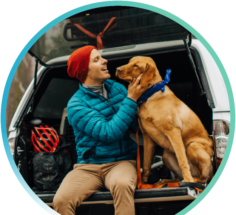 Guy and dog in back of car