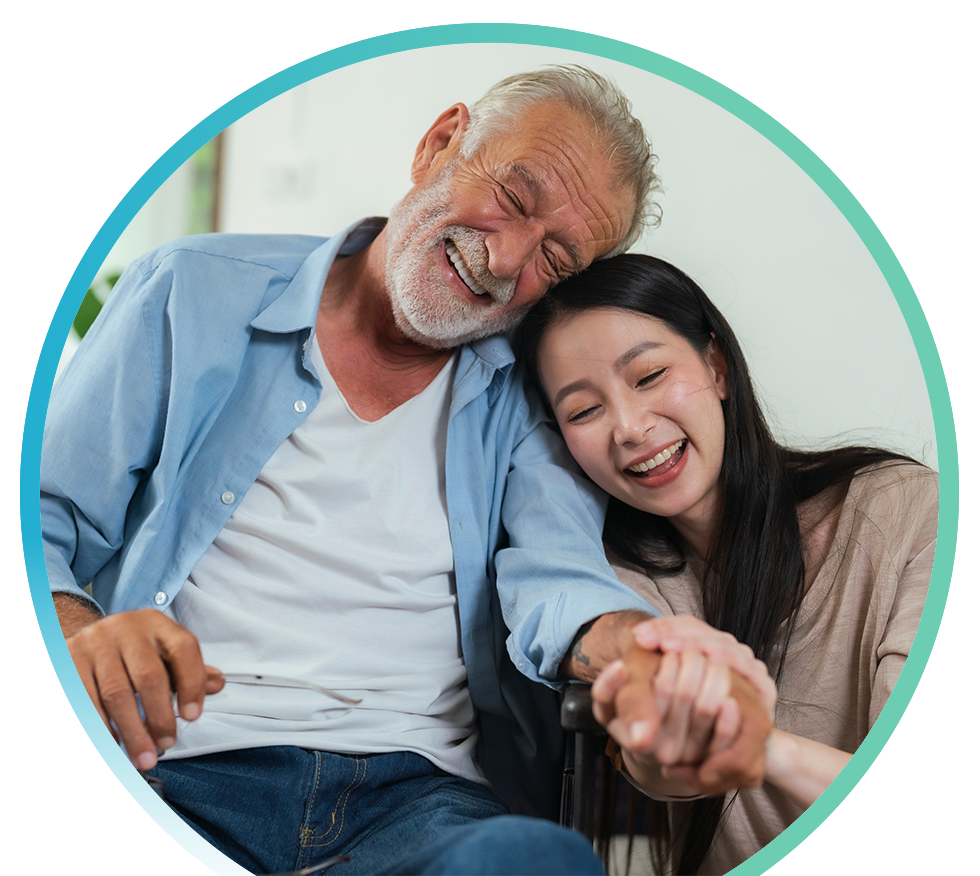 Older man and young woman smiling and holding hands.