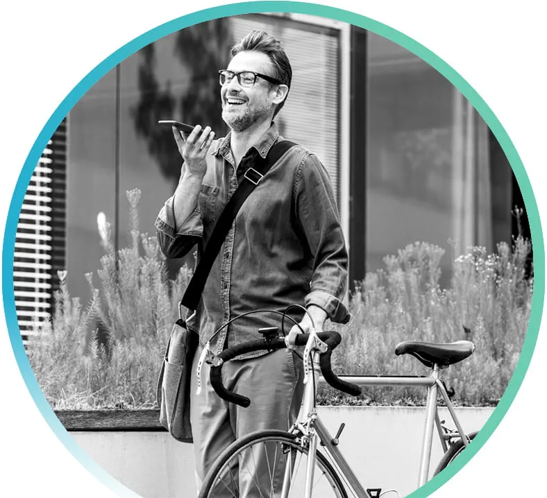 man standing with bicycle and speaking on his phone