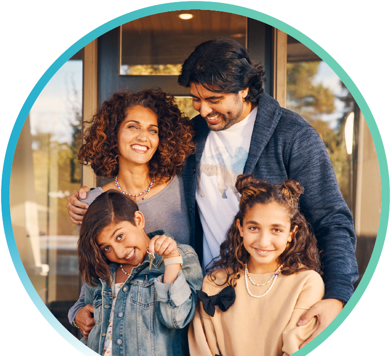 Mother, Father, and their two children taking a family photo on their front porch.