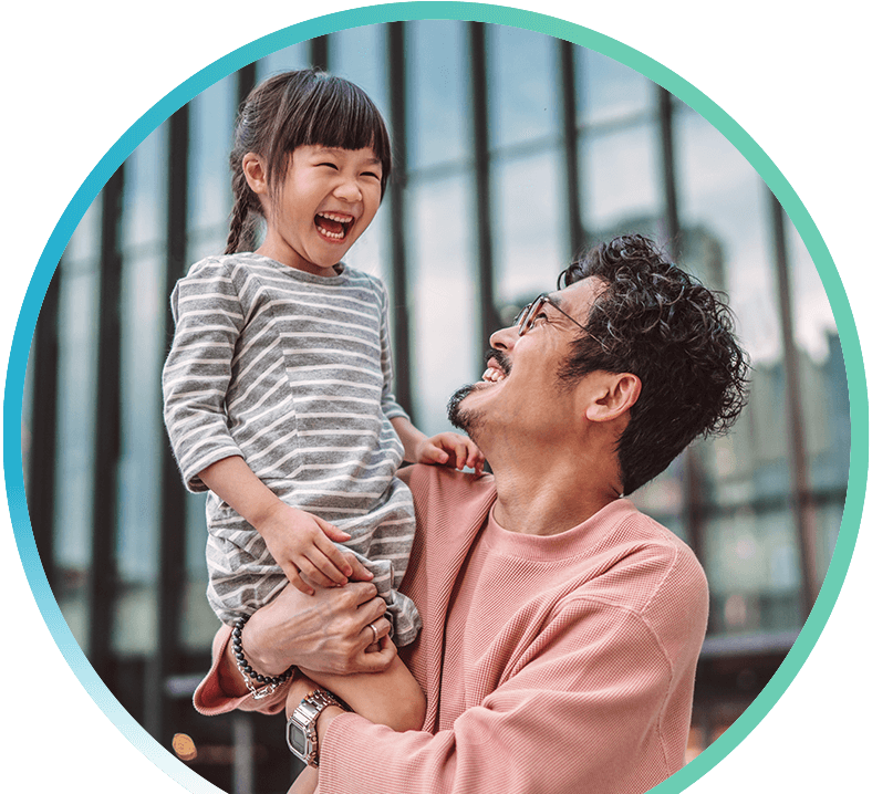 Man holding young daughter smiling