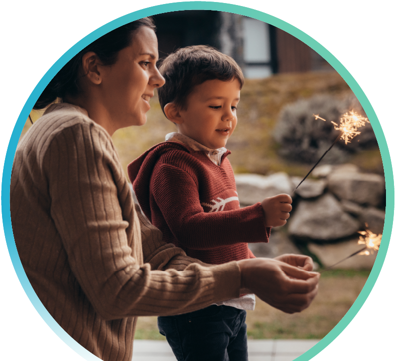 Woman and child outside enjoying sparklers