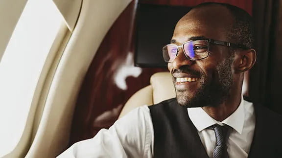 Man smiling sitting on plane