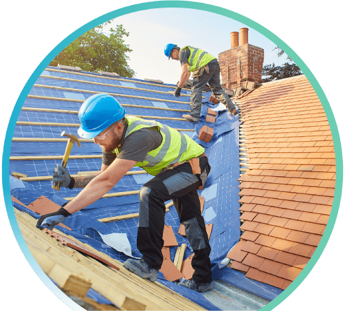 Workman installing a roof on a house