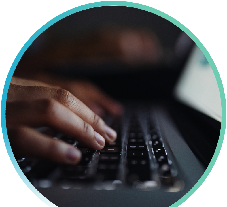 Close up of fingers typing on a laptop