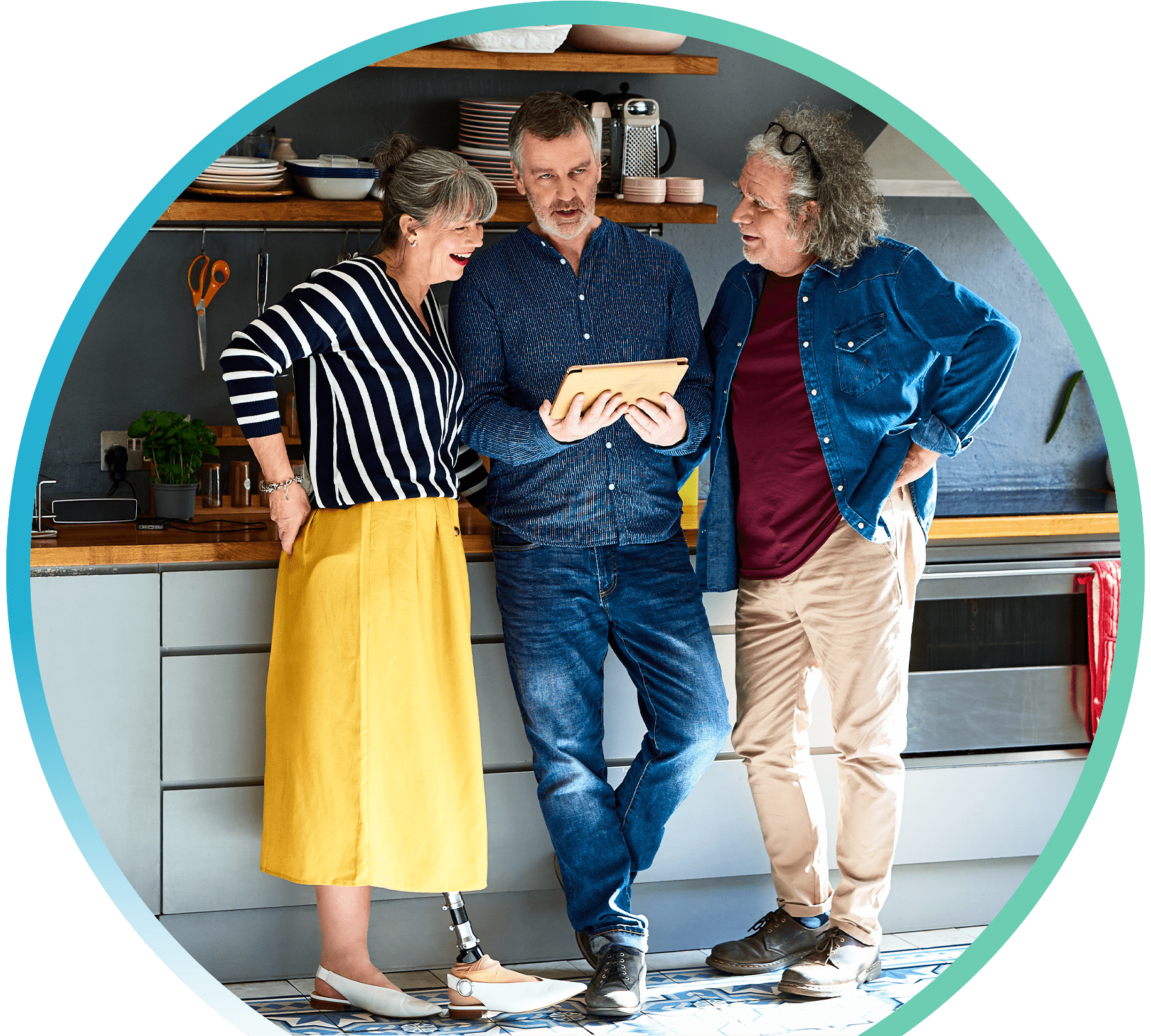 Three people in a kitchen huddled around a tablet