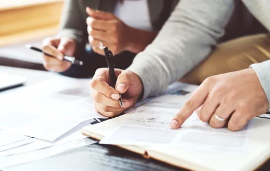 Two people looking over documents.
