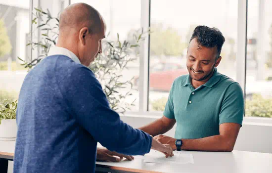 A man sitting down with a financial expert.