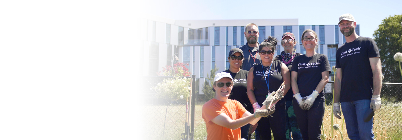 First Tech Federal Credit Union employees posing for a picture after a volunteer event working on the onsite community garden.