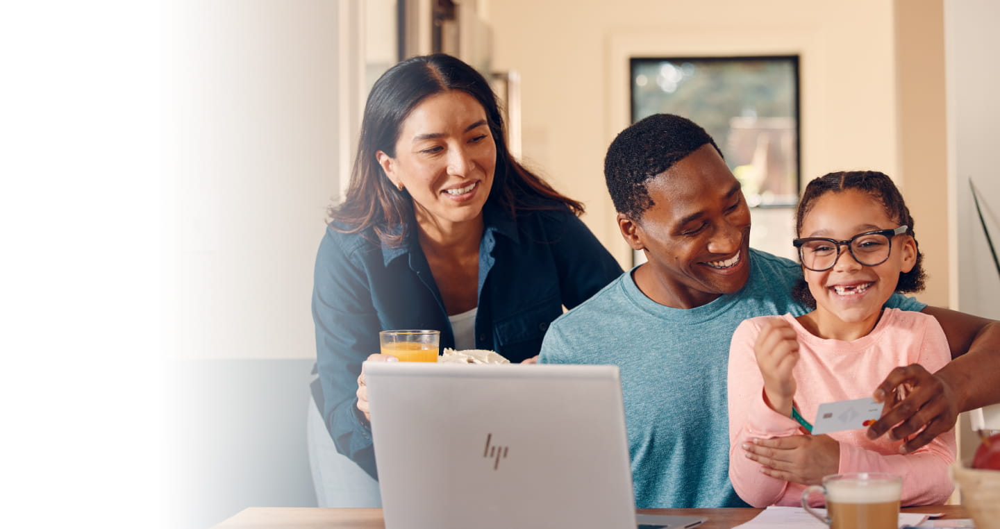 Parents with young child at a laptop computer